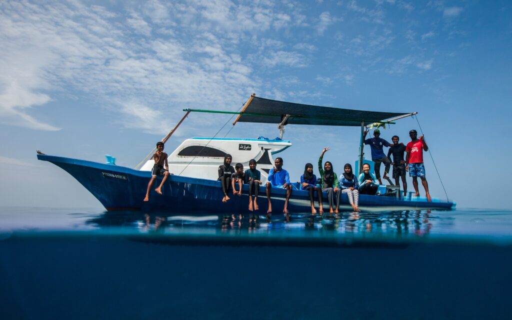 Photo shows Maldives community members being taken out on the Manta Trust research boat