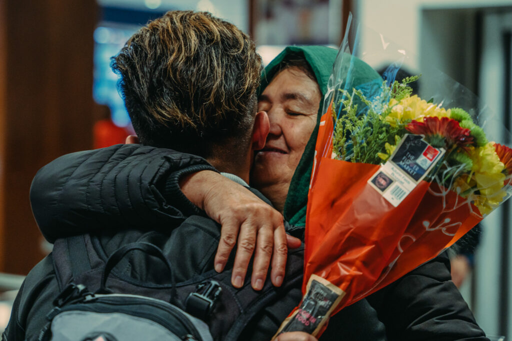 Double the difference donation impact - mother and son hugging in an airport