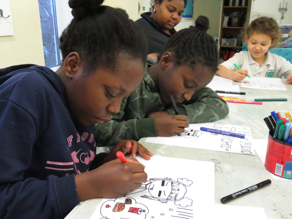 Double the difference donation impact - children in a classroom drawing on paper